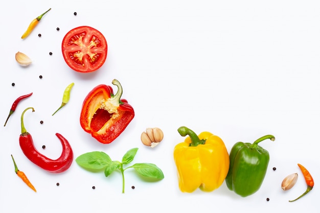 Various fresh vegetables and herbs on white