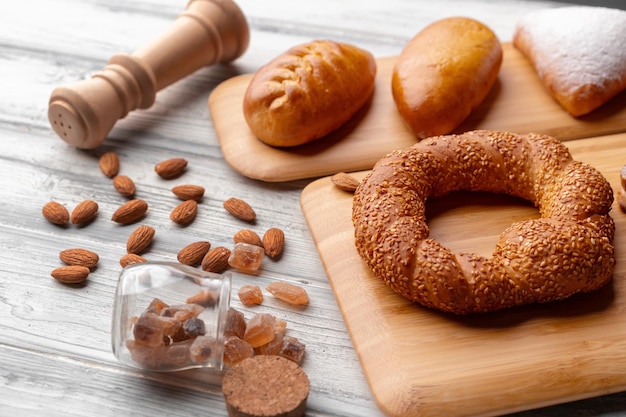 Various freshly baked sweet buns on wooden background