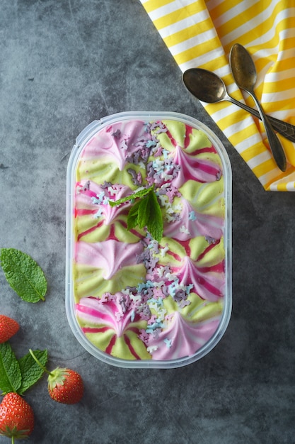 Various fruit and berries ice cream in plastic box 