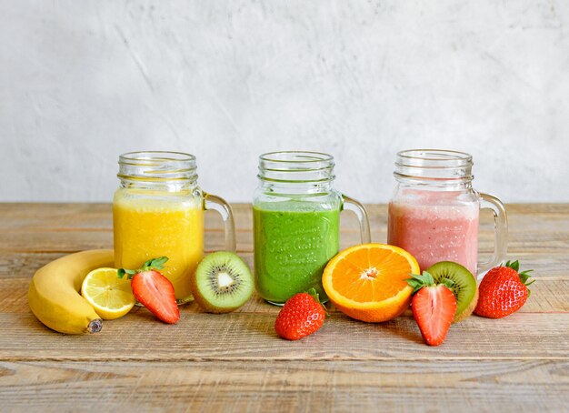 Various fruits in glass jar on table smoothie juice colorful