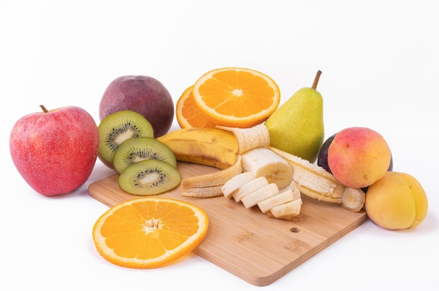 Various fruits in plate against white background