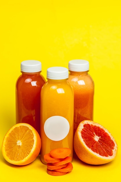 Photo various fruits on table against yellow background