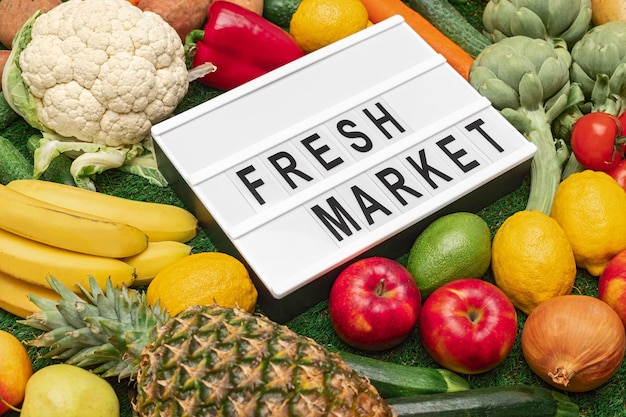 Various fruits and vegetables around signboard