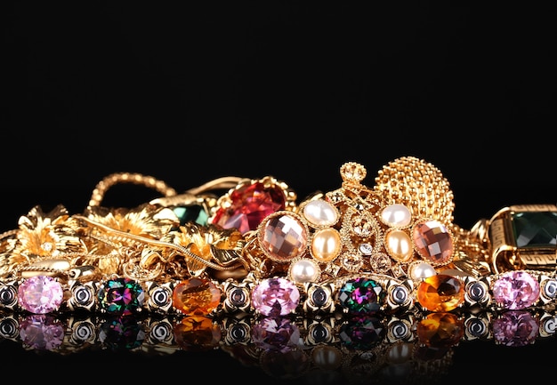 Various gold jewellery on black table