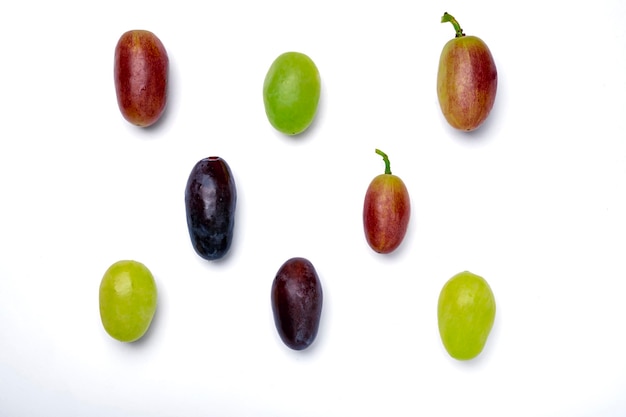 Various grapes are on the table. Isolated vines