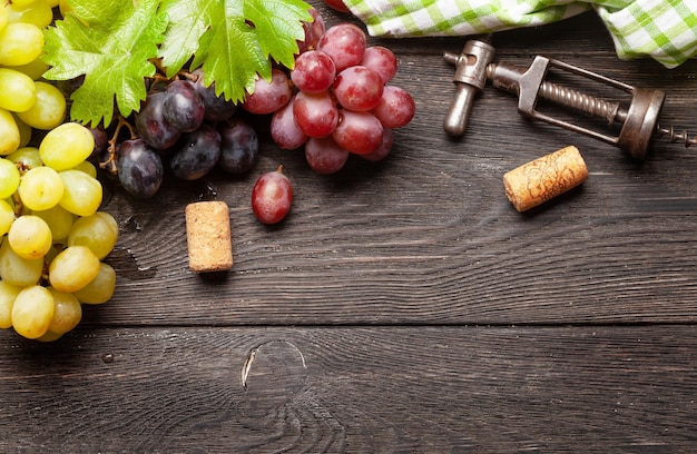 Various grapes wine corks and corkscrew