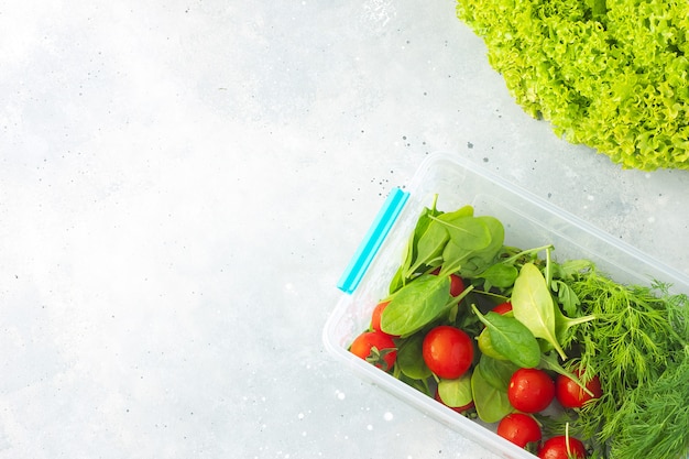 Various greens for salad on stone background