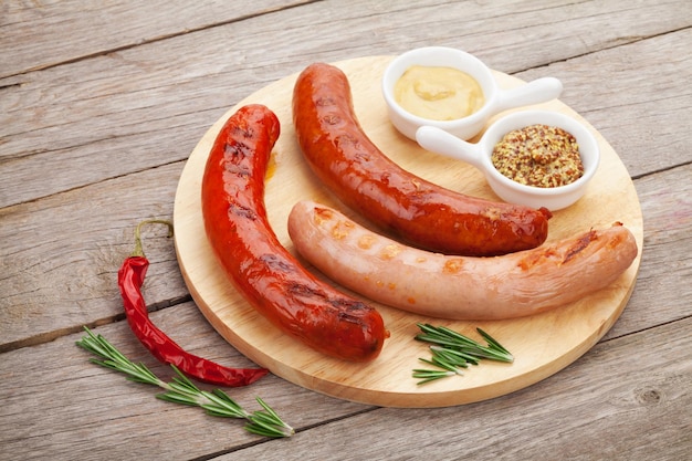 Various grilled sausages with condiments