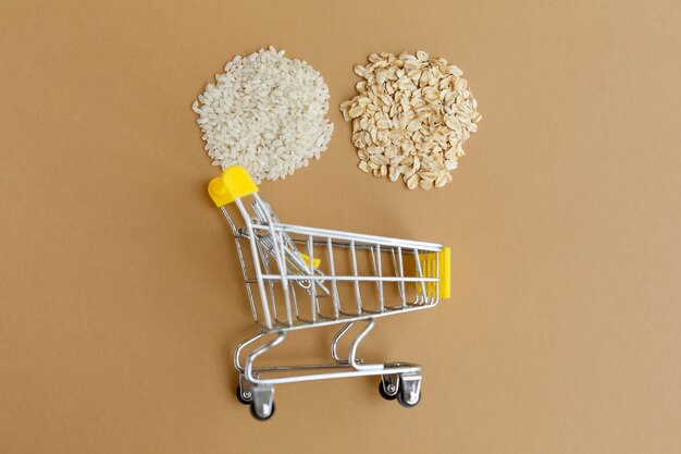 Various groats in a grocery cart on a brown background