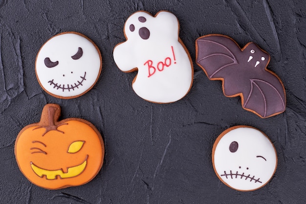 Photo various halloween biscuits on black background.