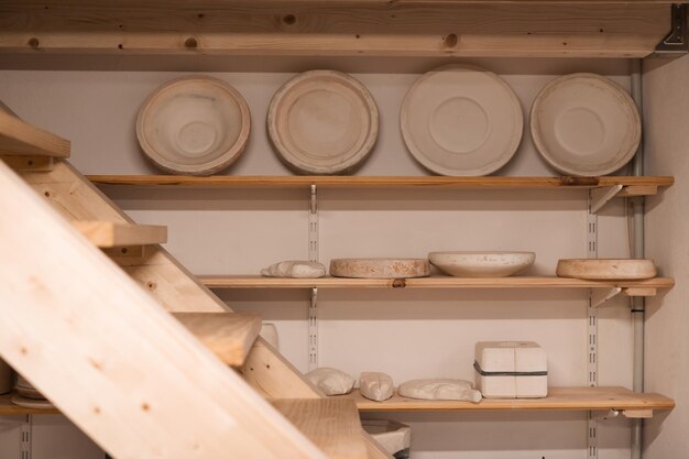 Photo various handmade ceramic empty jars on shelves in a small business