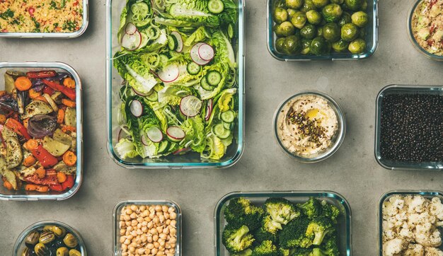 various healthy vegan or vegetarian dishes in glass containers