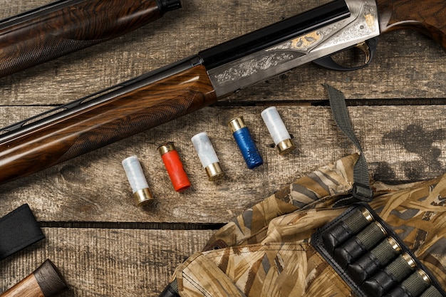 Various hunting equipment on old wooden background