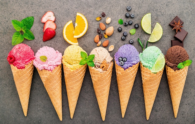 Various of ice cream flavor in cones  set up on dark stone background .