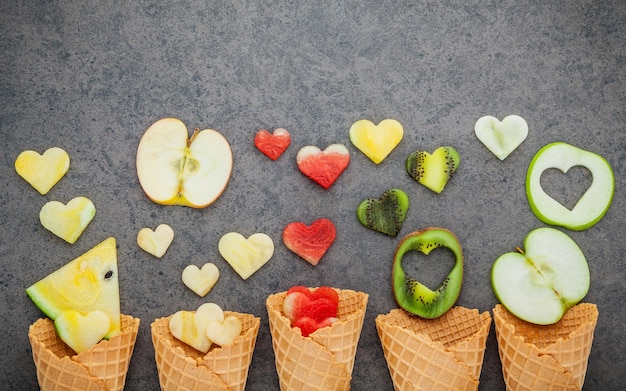 Various of ice cream flavor in cones setup on dark stone background . 