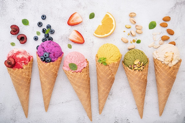 Various of ice cream flavor in cones  setup on white stone background