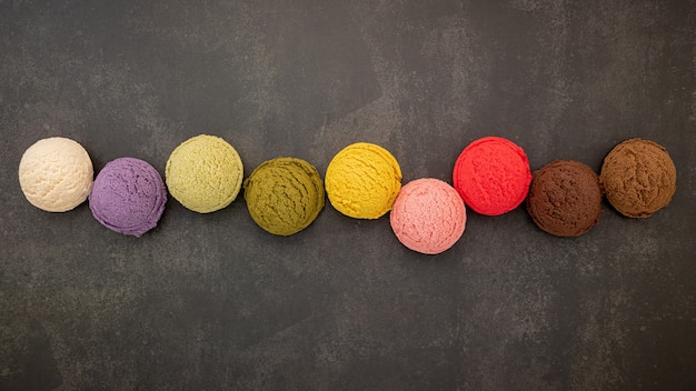 Various ice cream flavors on a concrete table