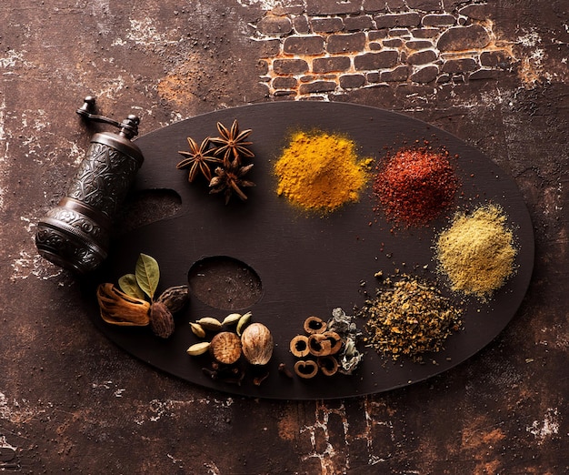 Various indian spices, seasonings and spicy and spice mill on concrete texture