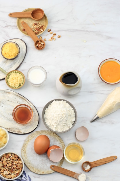 Various Ingredients for Baking Preparation on Marble Table. FLour, Egg, Cream, Honey, Cheese, and Chopped Almond Ready to Make Baking Mix Batter