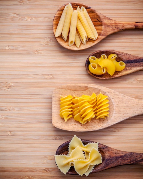 Various kind of Pasta on bamboo cutting board with flat lay.