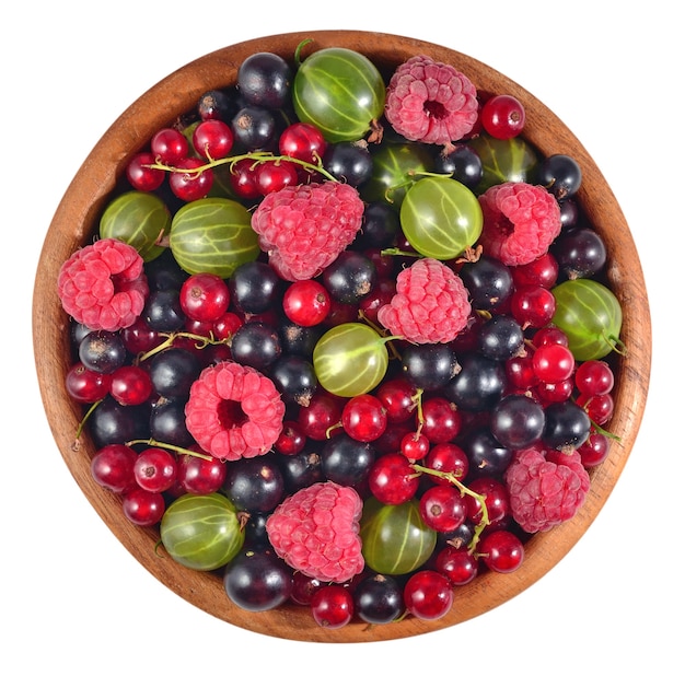 Various kinds of fresh berries in a wooden bowl on a white background