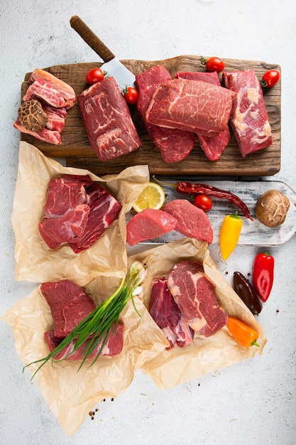 various kinds of raw meat vegetables and spices on the table