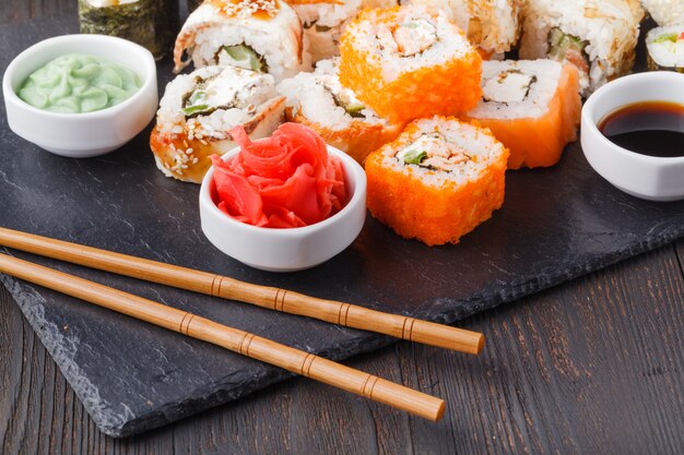 Various kinds of sushi food served on black stone