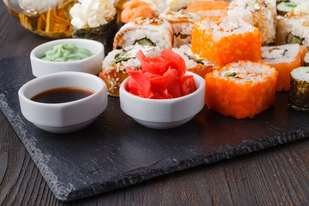 Various kinds of sushi food served on black stone