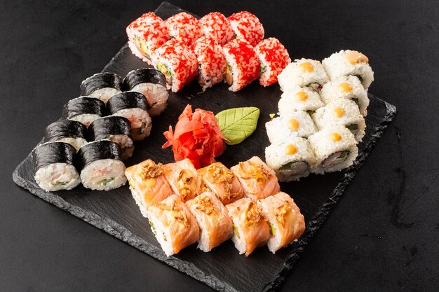 Various kinds of sushi served on black