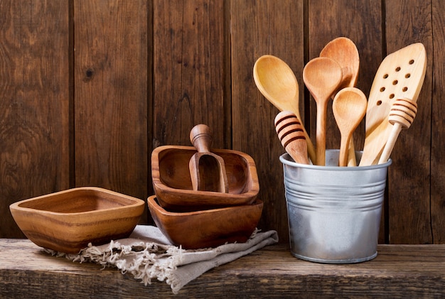 Various kitchen utensils on wooden shelf