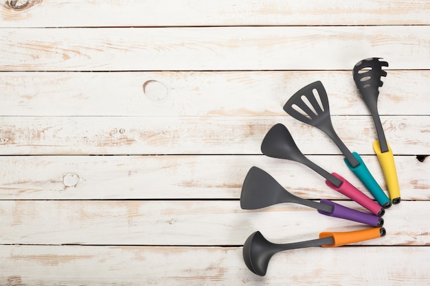 Various kitchen utensils on wooden table