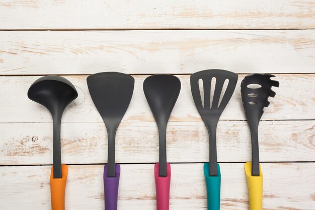 Various kitchen utensils on wooden table