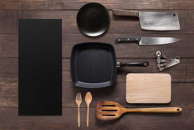 Various kitchenware utensils on the wooden background