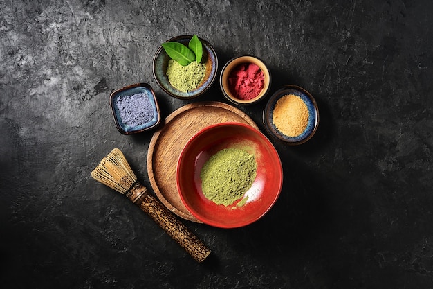 Various matcha tea powders on a dark concrete background 