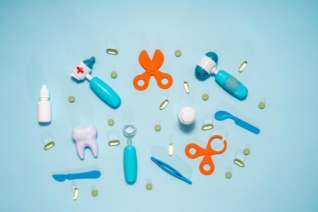 Various medical supplies on blue background Flat lay