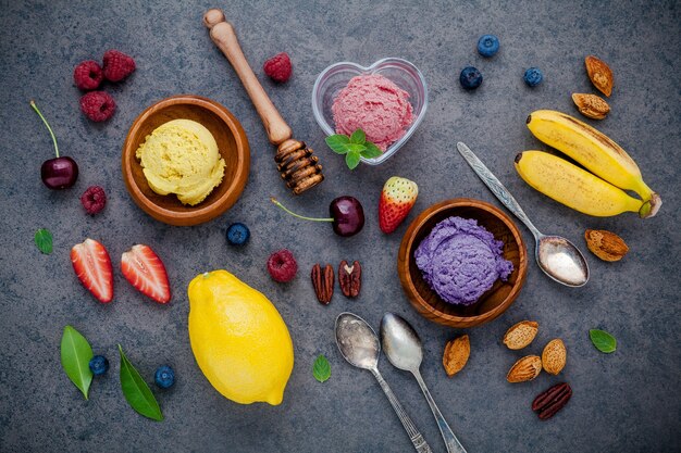 Various mixed fruits on dark stone background for sweets menu design.