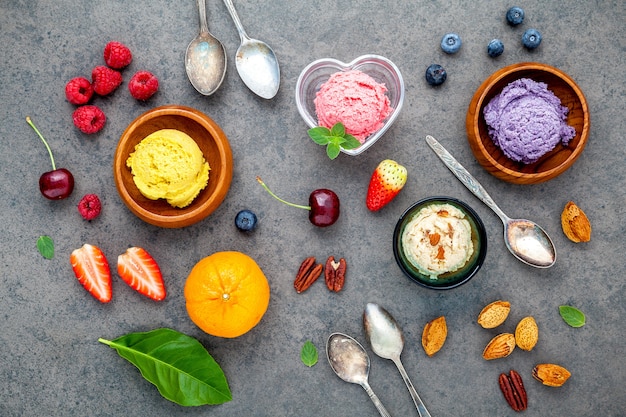 Various mixed fruits on dark stone background .