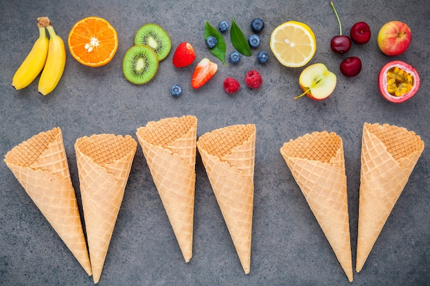 Various mixed fruits on dark stone background .