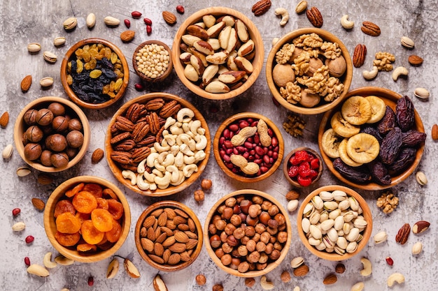 Various Nuts and dried fruits in wooden bowls