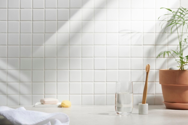 Various objects on a white tile background with warm sunlight shining through