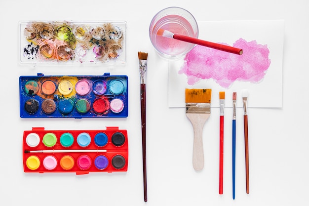 Various paint brushes and palette in box