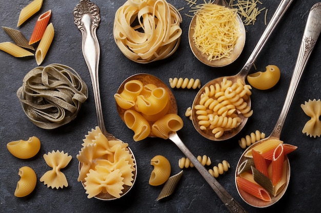 Various pasta on spoons