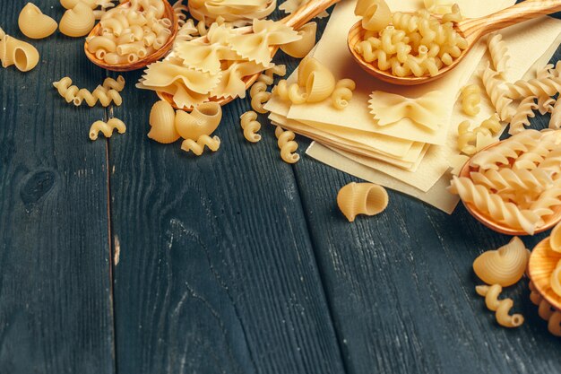 Various pasta on wooden spoons