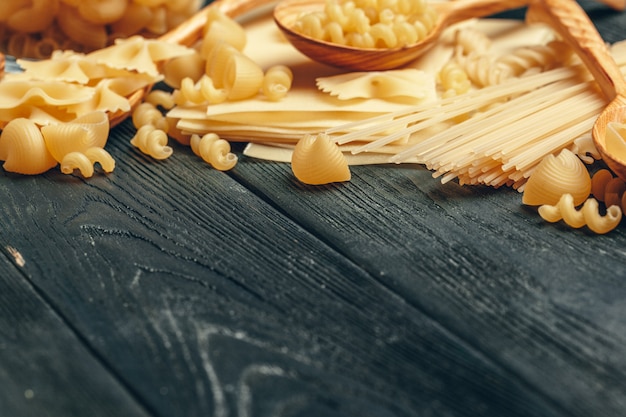 Various pasta on wooden spoons