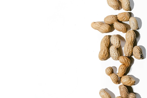 Various peanuts with shell on white background. copy space