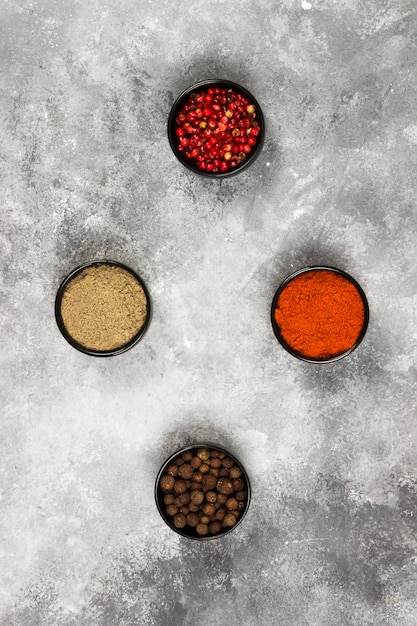 Various pepper on a gray background. Top view. Food background