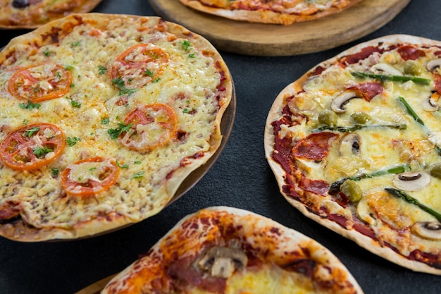 Various pizza arranged on a wooden tray