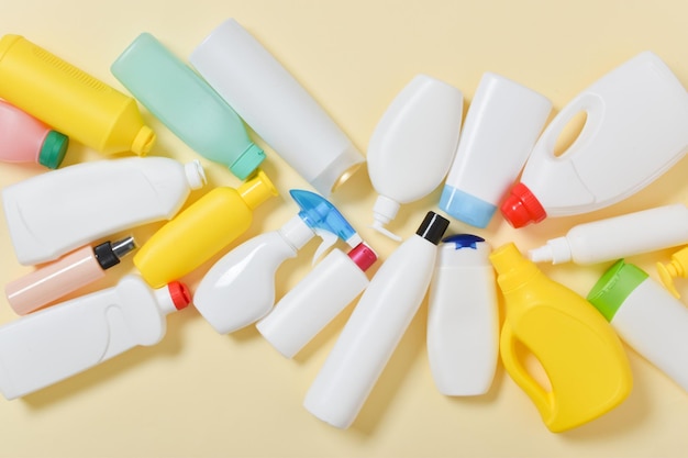 various plastic bottles scattered on a yellow background