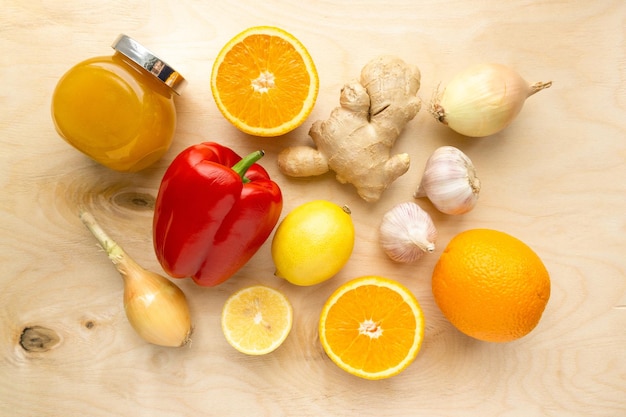 Various products for immunity boosting. Vegetable, fruit and honey on wooden background, top view