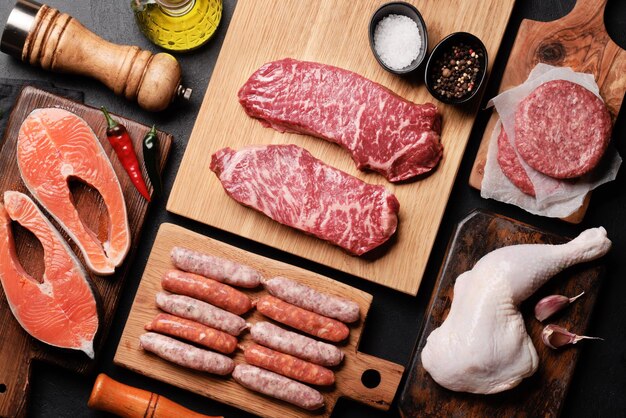 Photo various raw meat and fish steaks sausages salmon chicken and spices